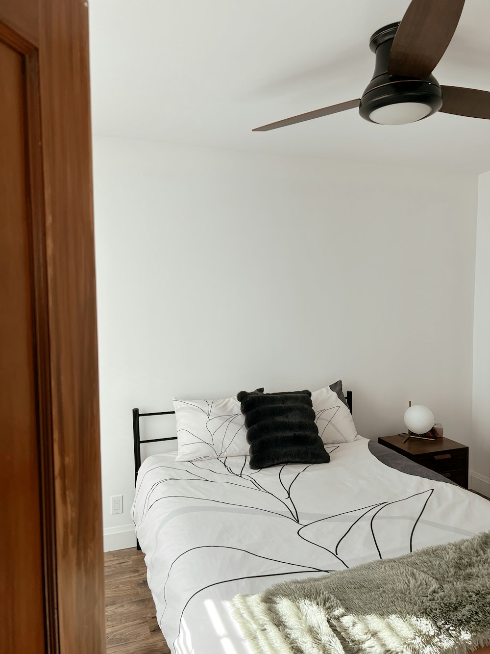 a bedroom with a bed and a ceiling fan