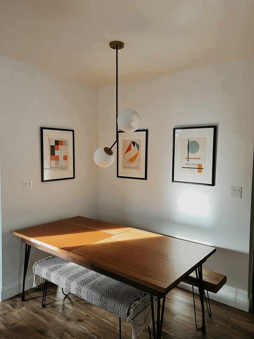 a dining room table with a bench underneath it