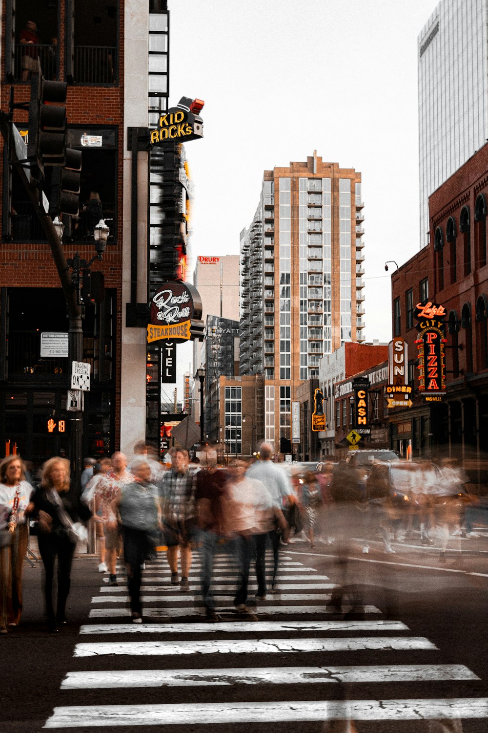 a group of people walking across a cross walk