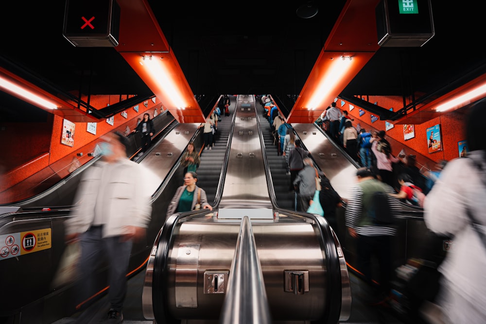 a group of people riding down an escalator