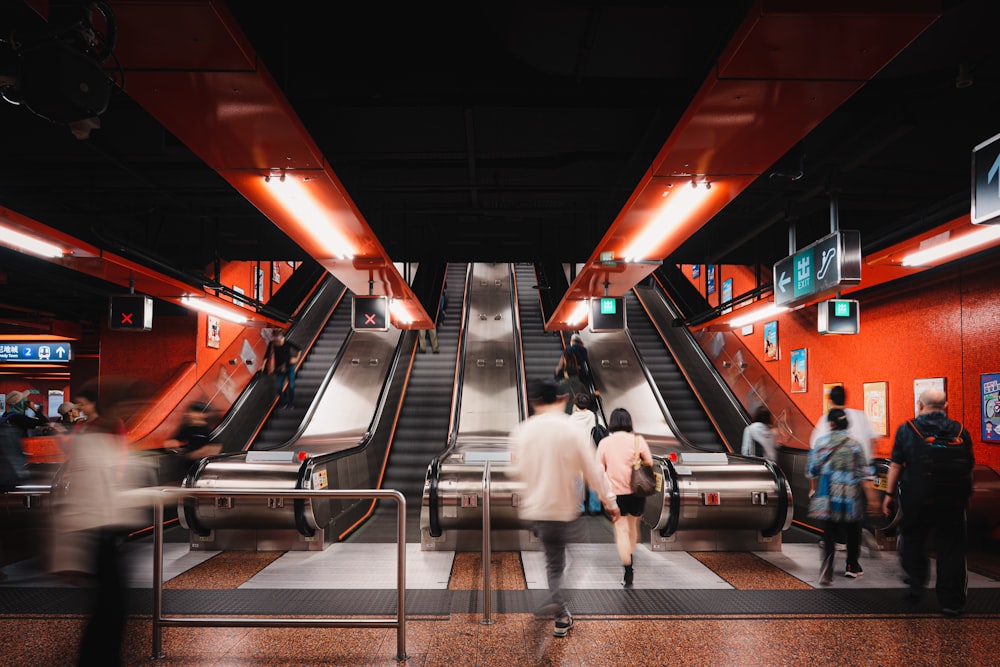 a group of people moving down an escalator