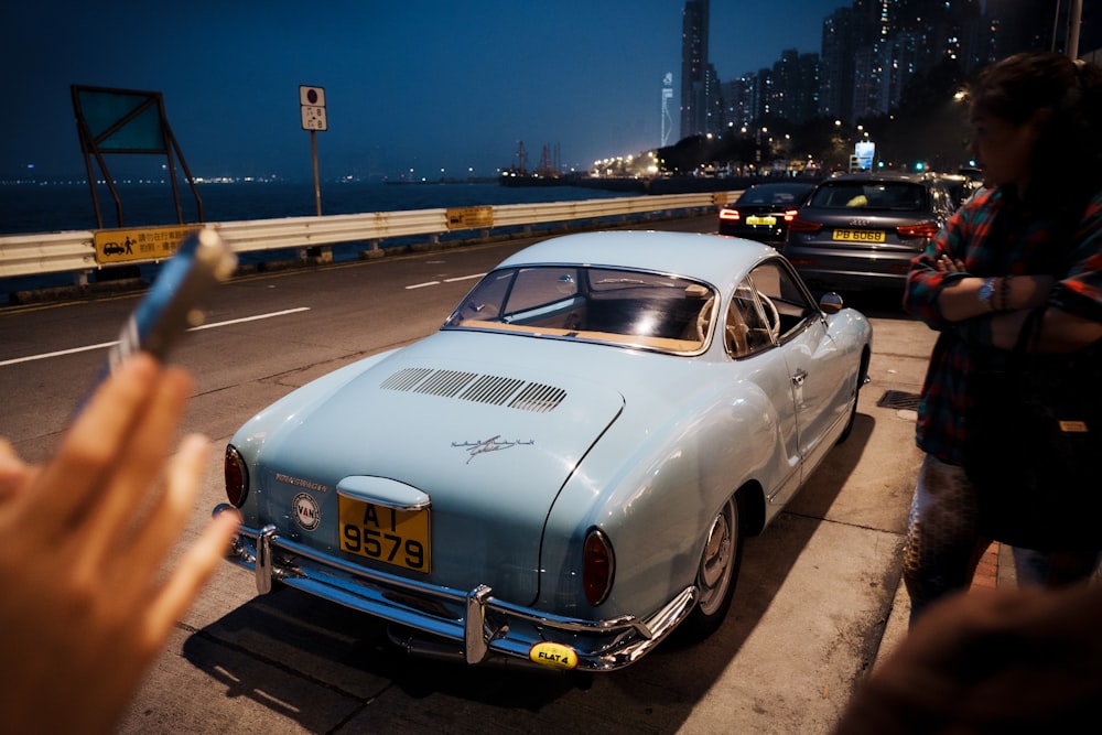 a blue car parked on the side of a road