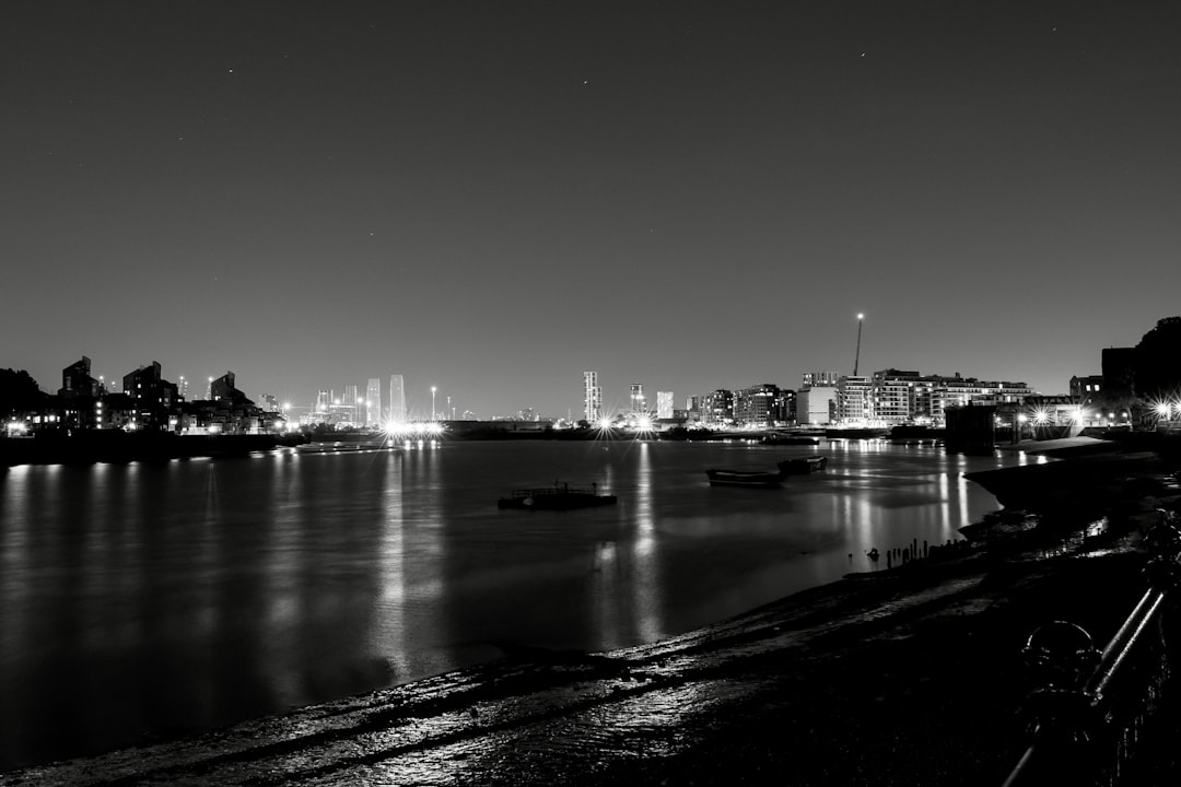 a black and white photo of a city at night,