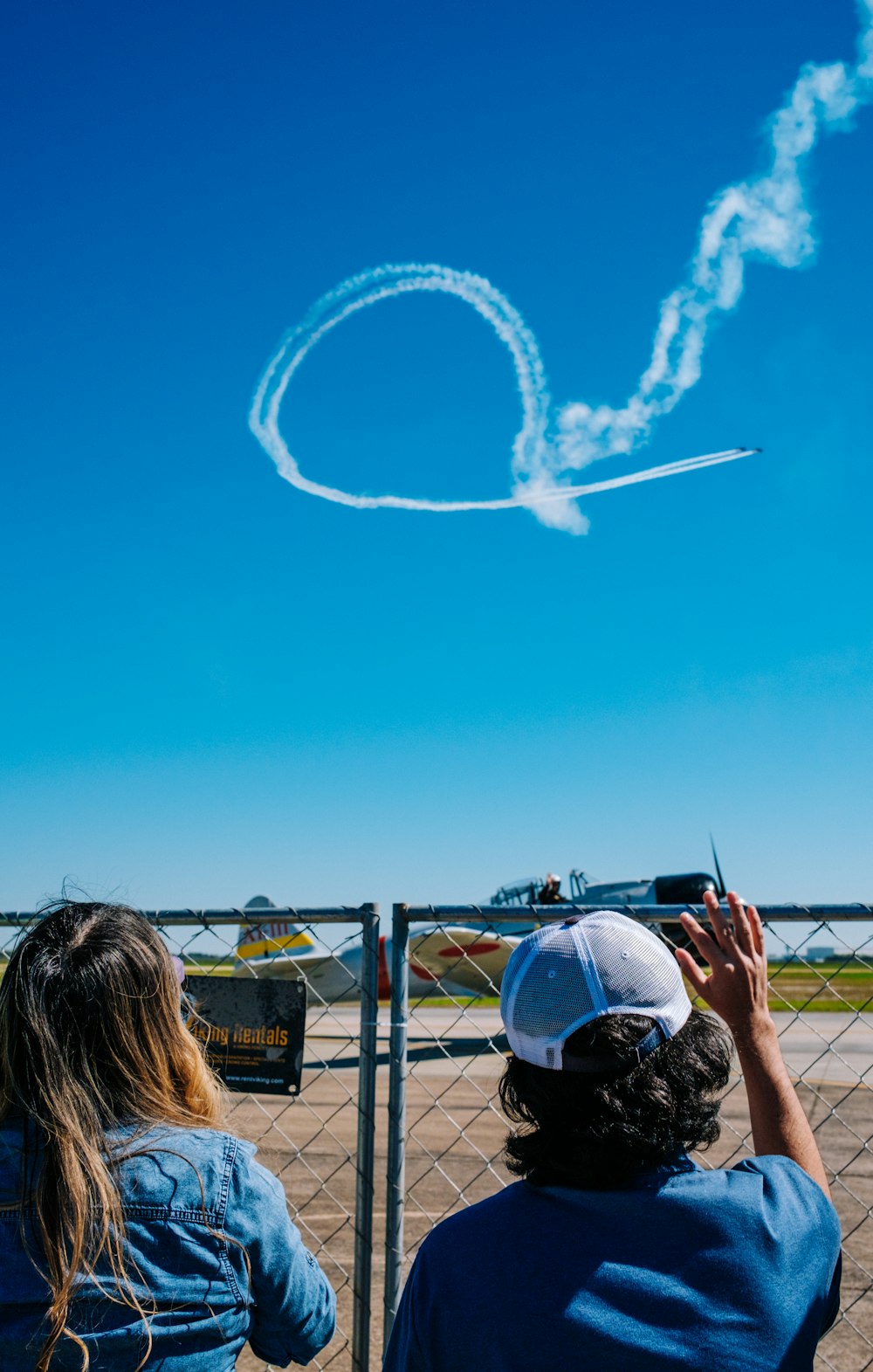 a couple of people that are flying a kite