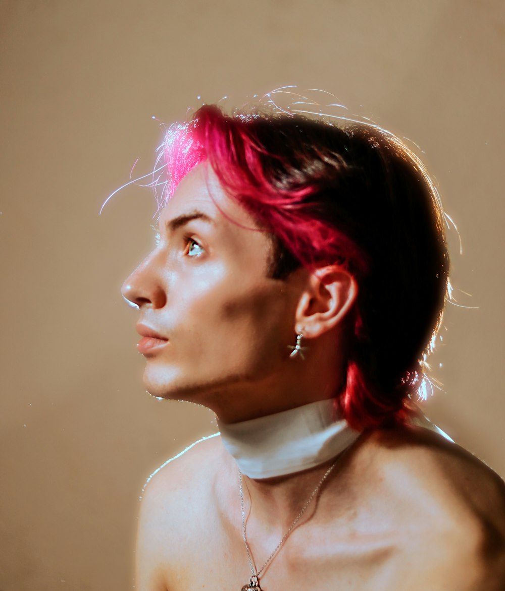 a woman with pink hair wearing a choker