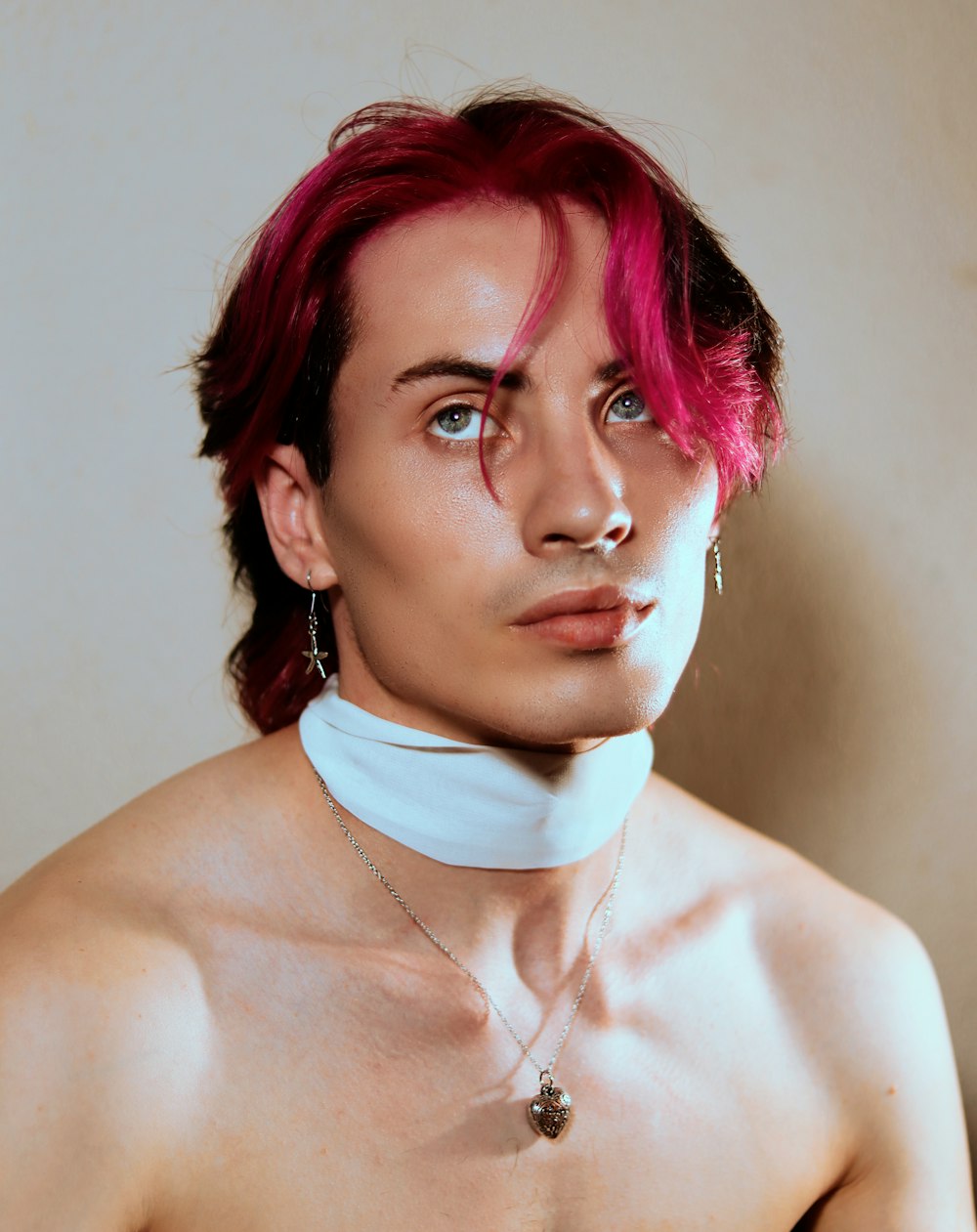 a man with red hair wearing a choker