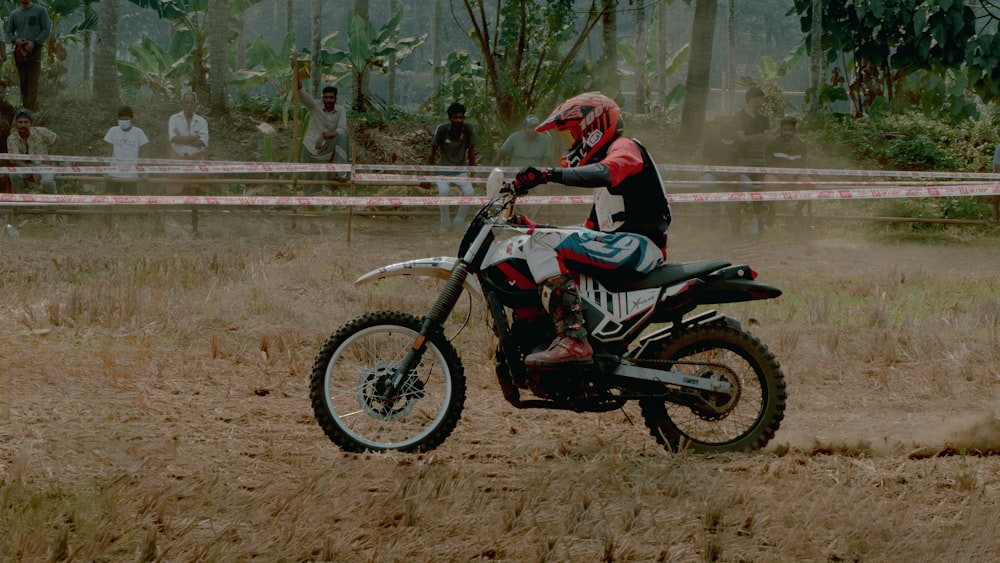 a man riding a dirt bike on top of a dirt field