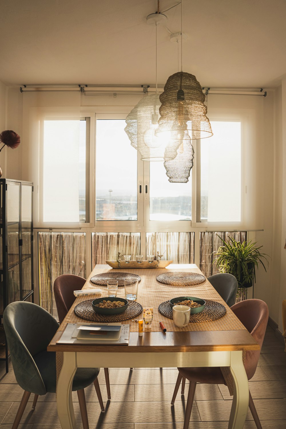 a dining room table with plates and bowls on it