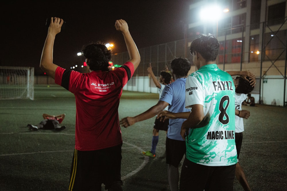 a group of people standing on top of a soccer field