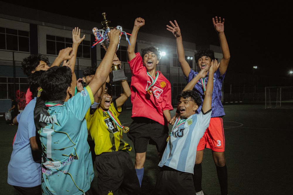 a group of young men standing on top of a soccer field