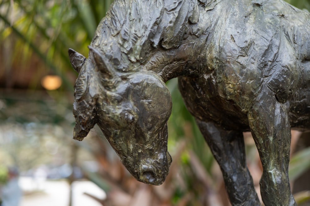 a statue of a horse with a baby horse on its back