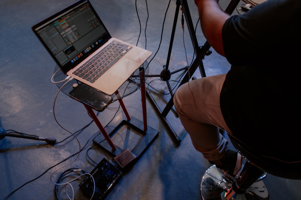 a person sitting in front of a laptop computer