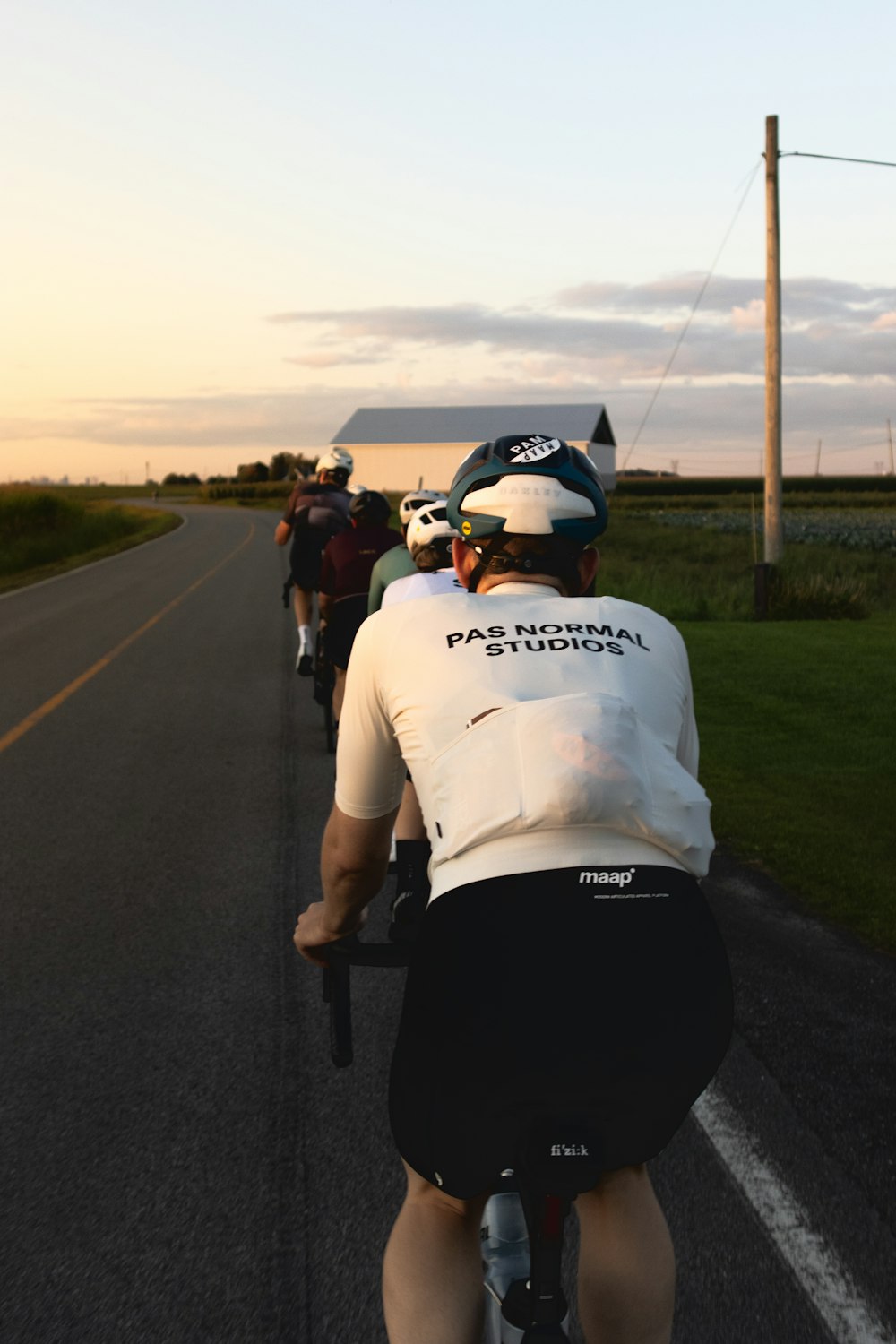 a group of people riding bikes down a road