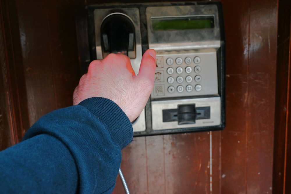 a person is pressing a button on a phone