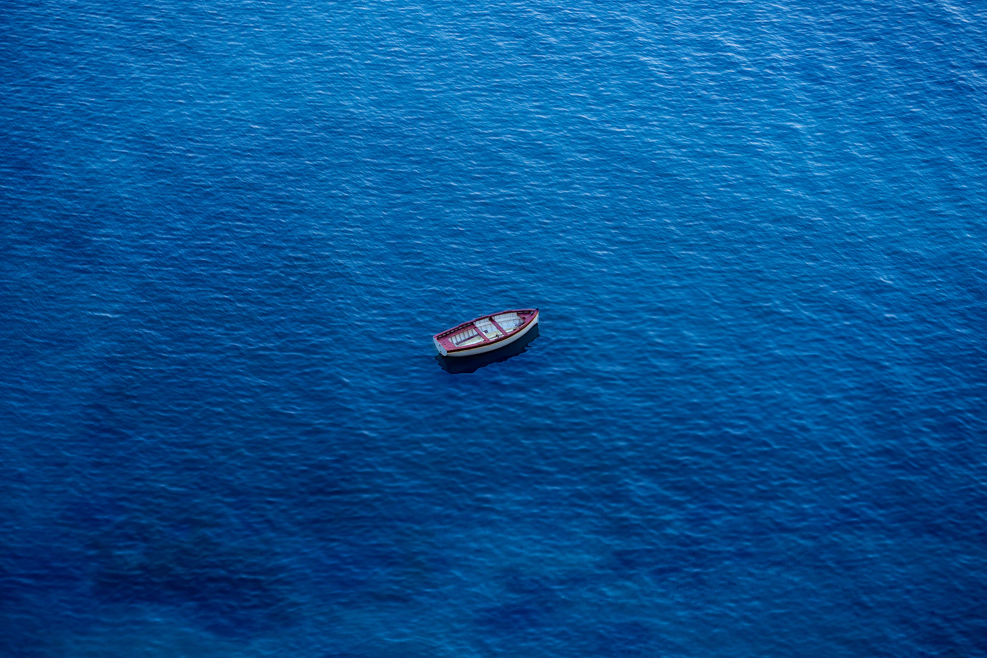 a small boat floating on top of a large body of water