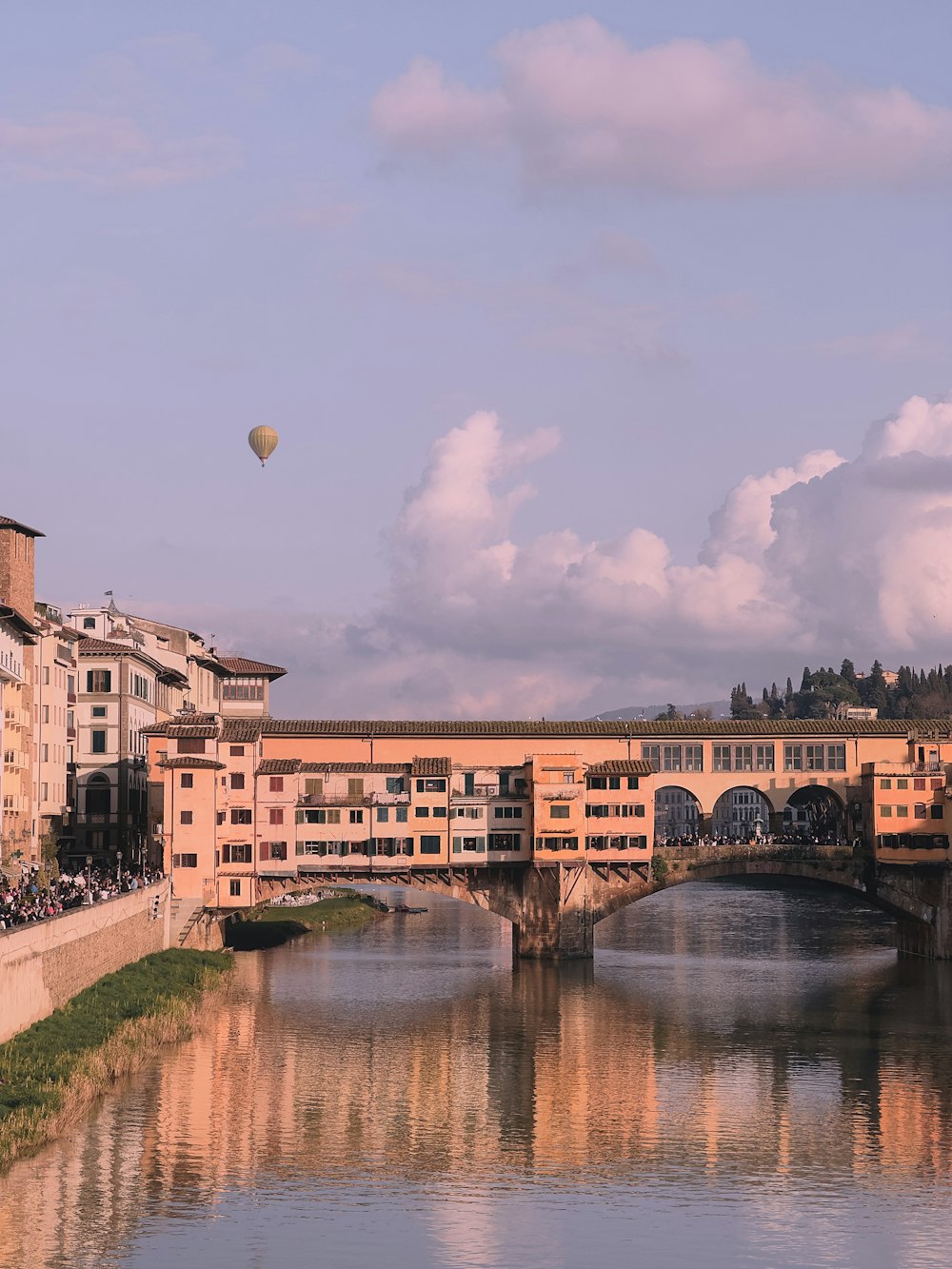 a bridge over a body of water with a bunch of buildings in the background