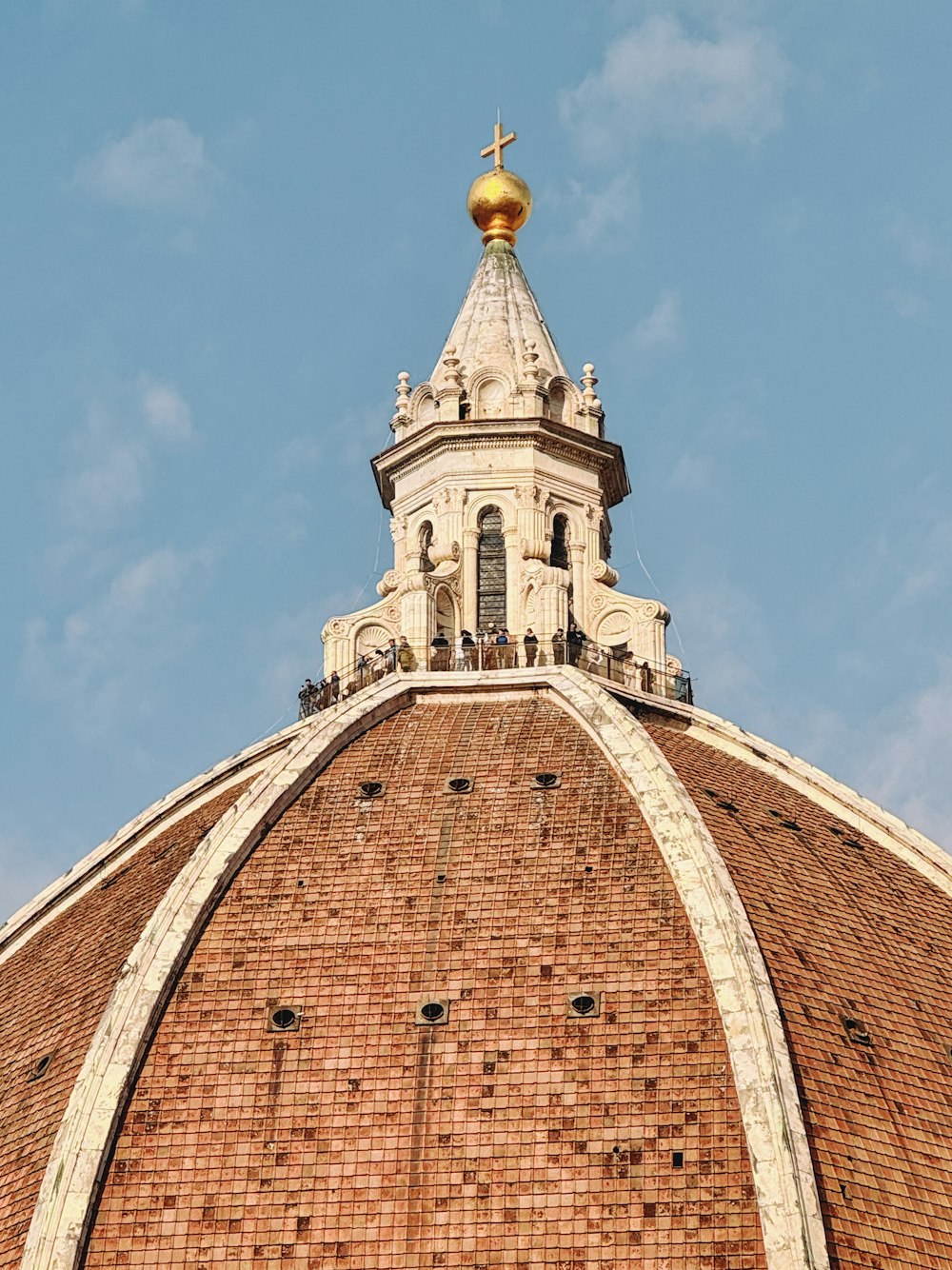 the top of a brick building with a golden dome
