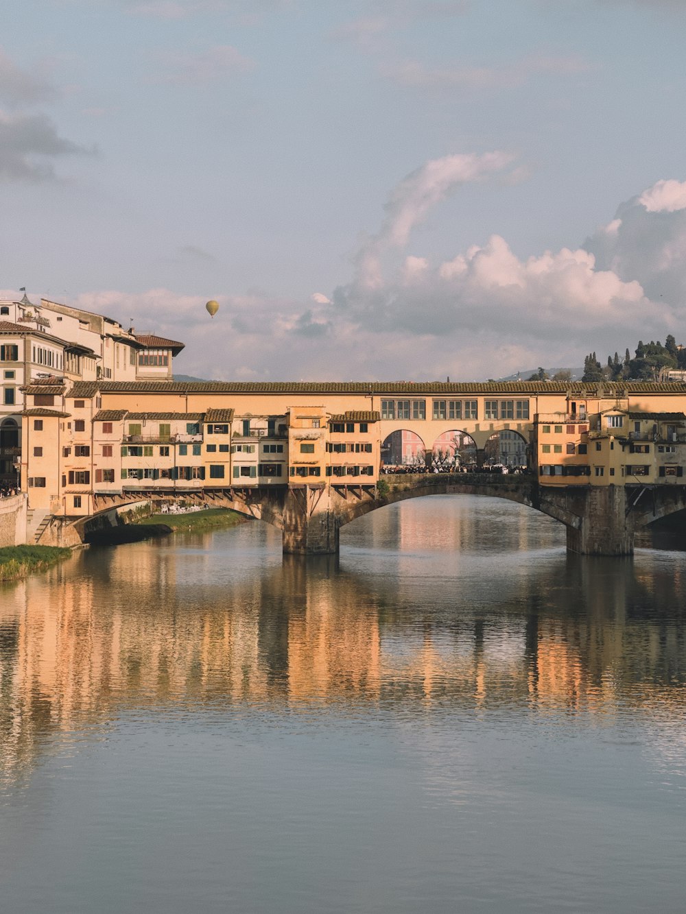 a bridge over a body of water with buildings in the background