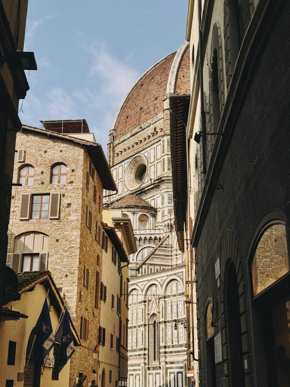 a narrow street with a church in the background