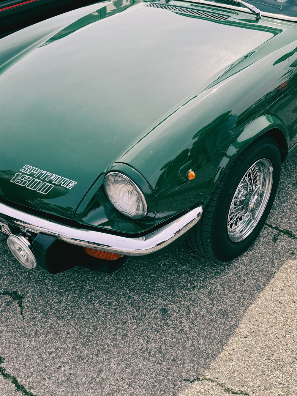 a green sports car parked in a parking lot