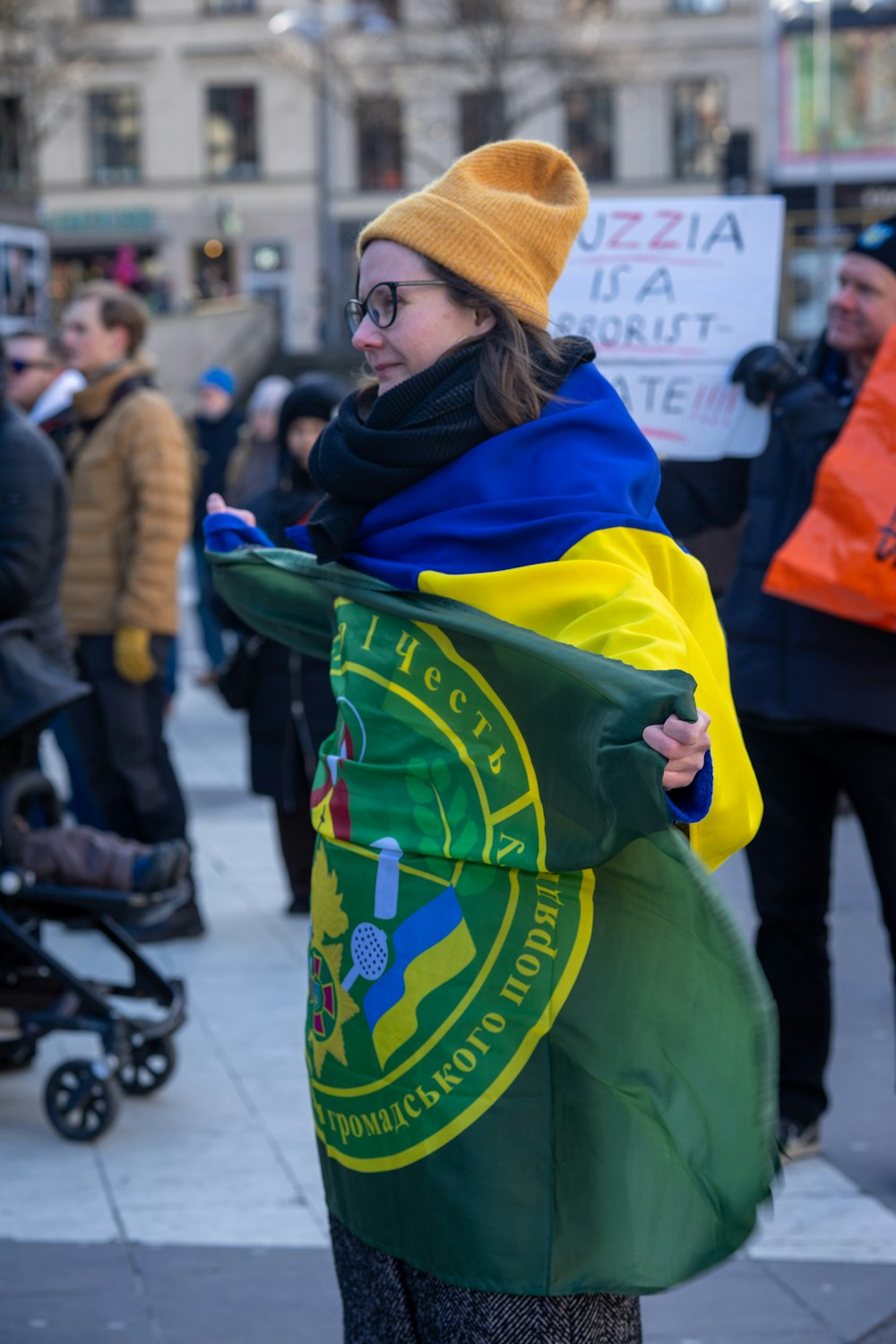 a woman is holding a flag and a cell phone