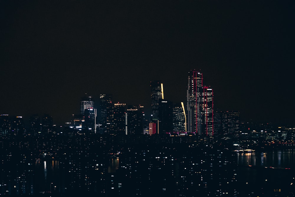 a night view of a city with a lot of tall buildings
