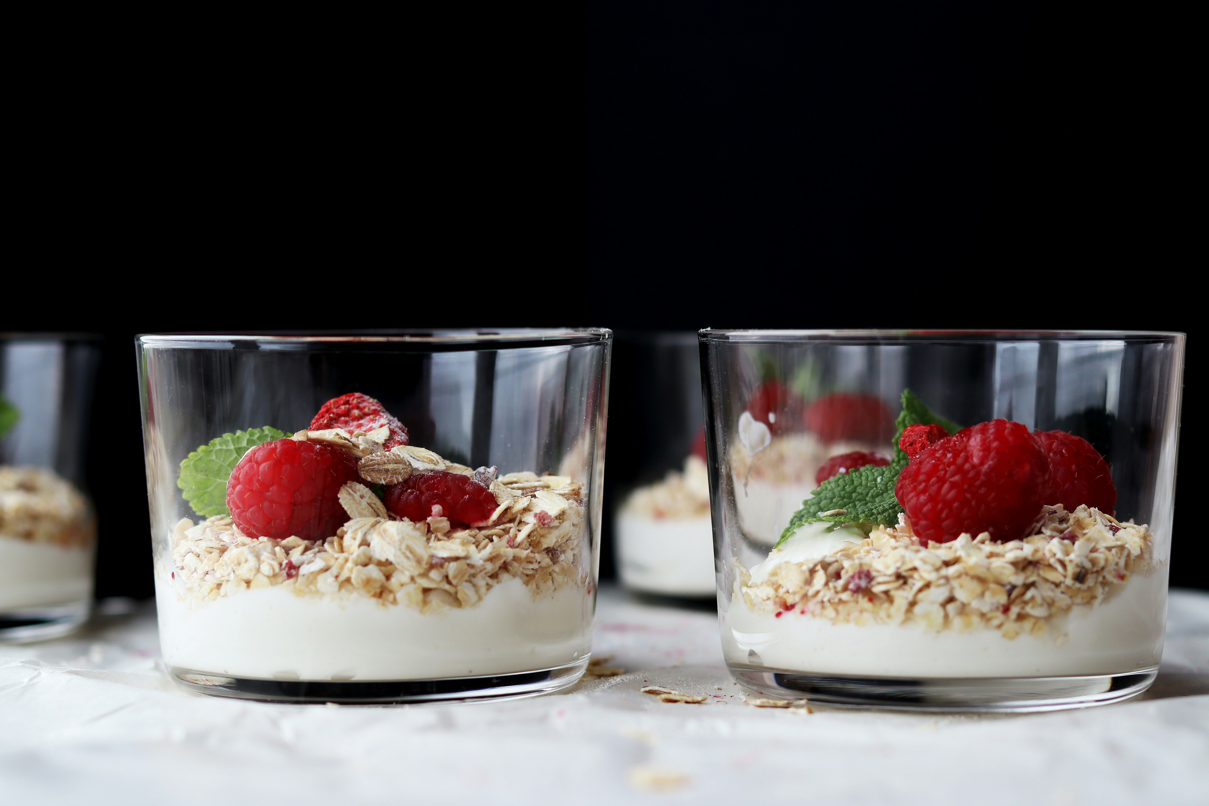 Glasses of yogurt with raspberries and granola