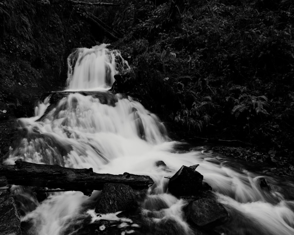 a black and white photo of a waterfall