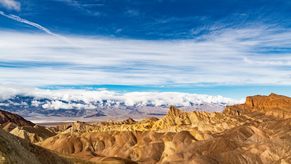 a view of a mountain range with clouds in the sky