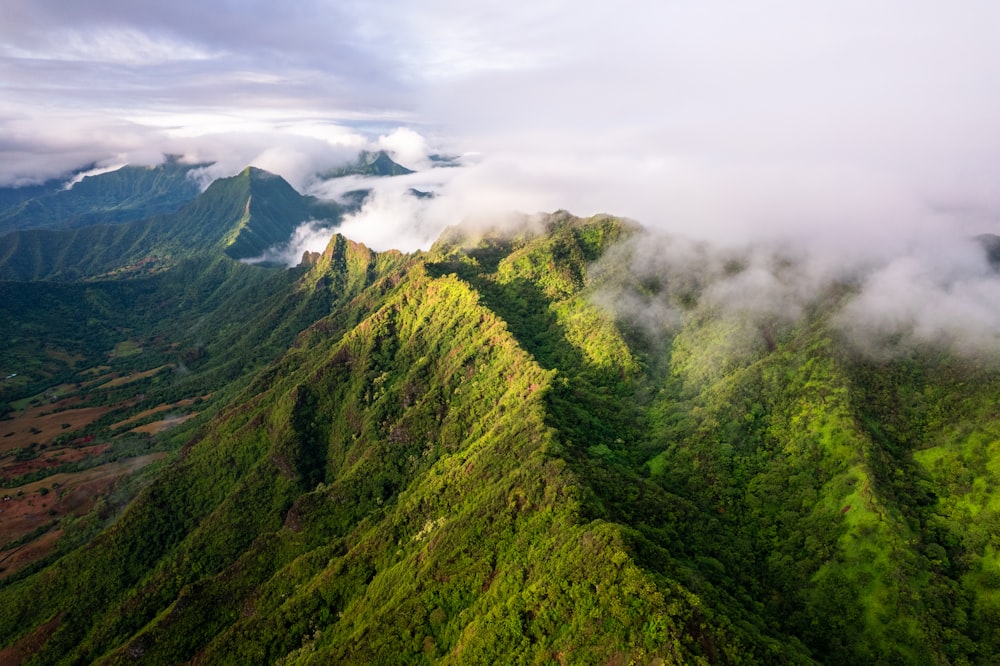 an aerial view of a lush green mountain range