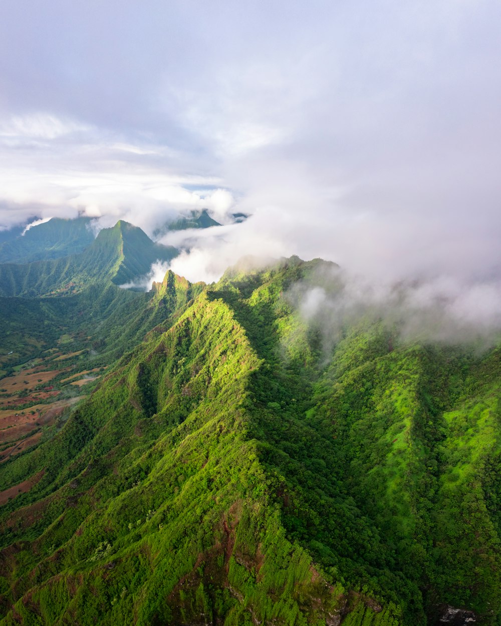 an aerial view of a lush green mountain range