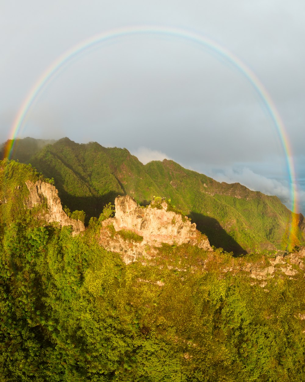 a double rainbow is seen over a mountain range