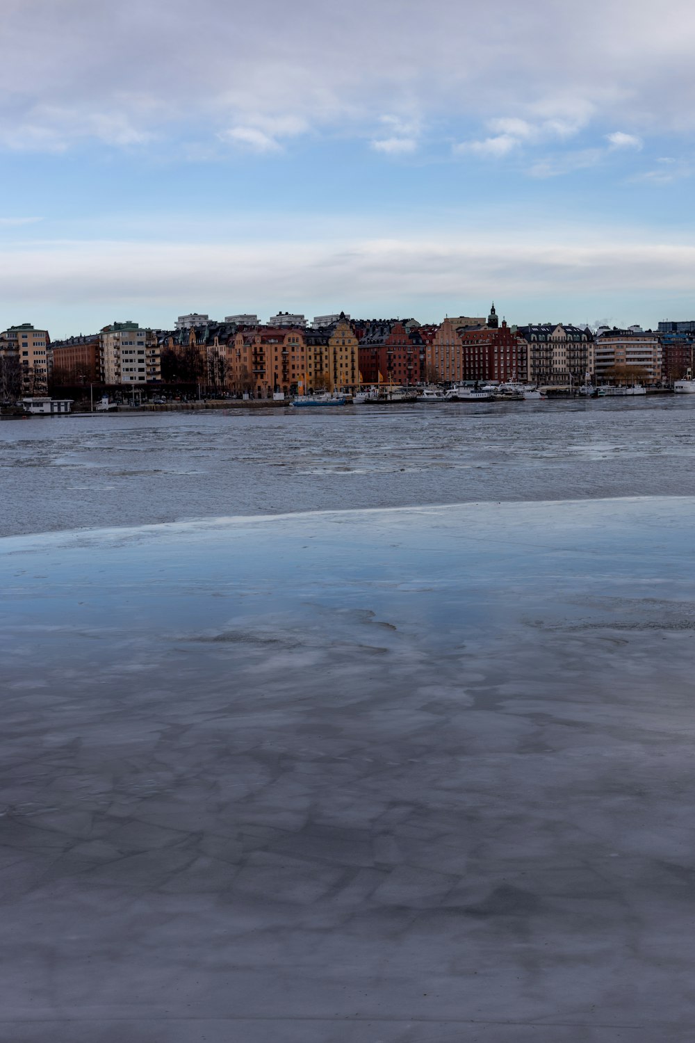 a large body of water with buildings in the background