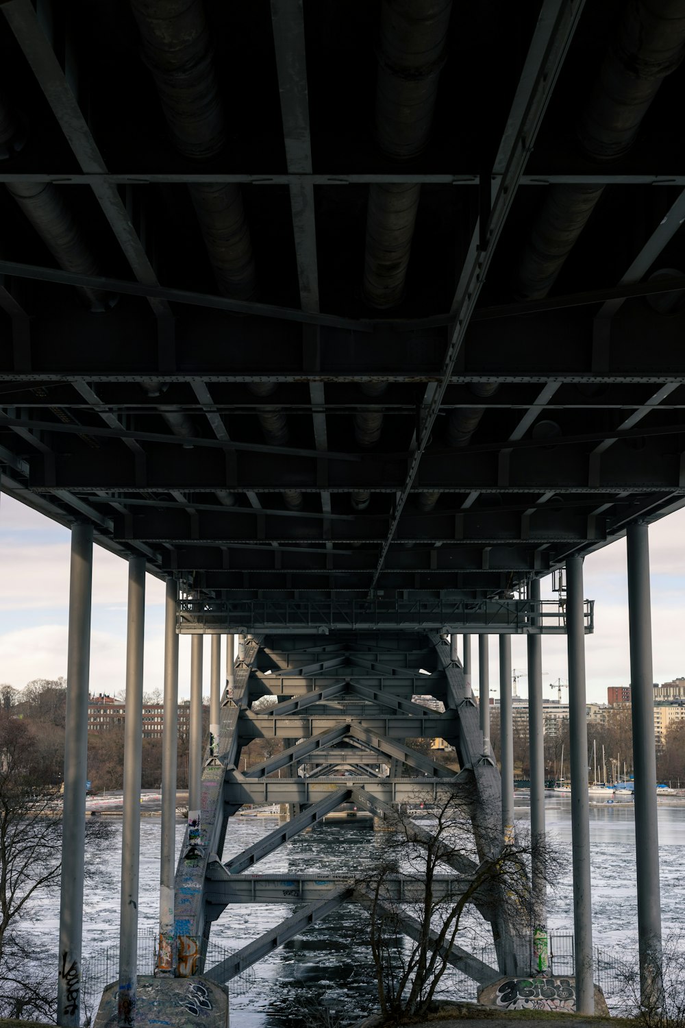 the underside of a bridge over a body of water