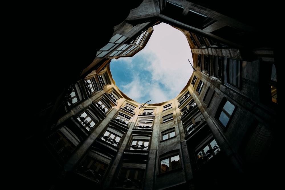 looking up at a circular window in a building