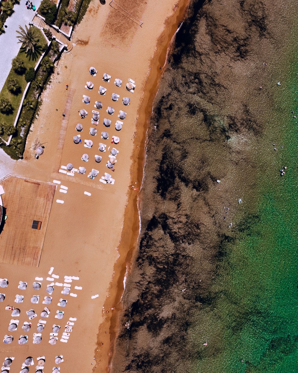 an aerial view of a beach with many boats