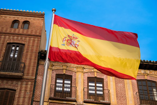 a flag flying in front of a building