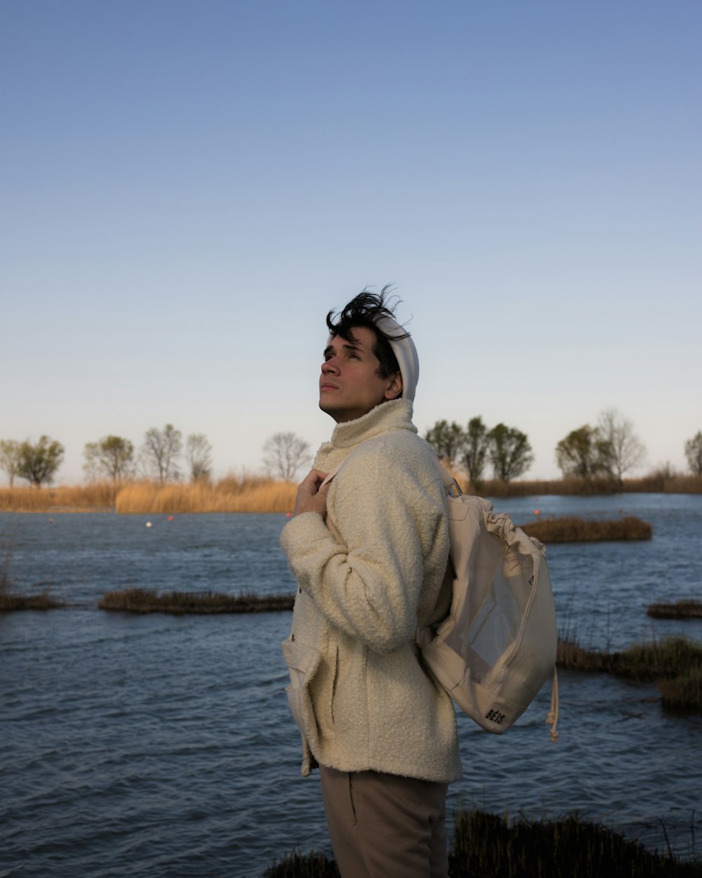 a woman standing by a body of water