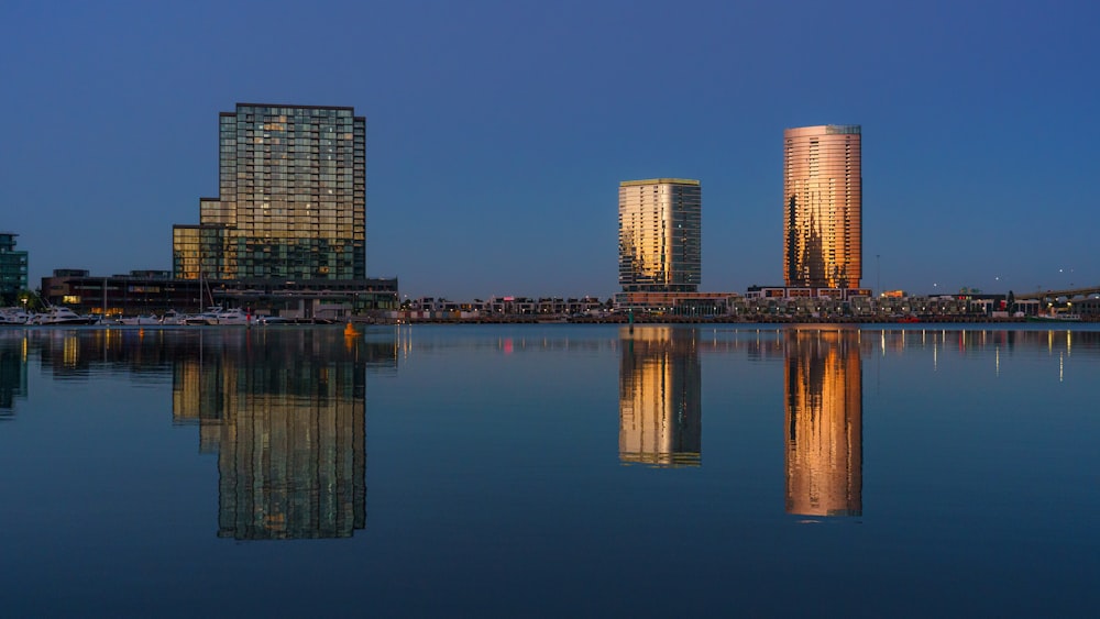 a large body of water with buildings in the background