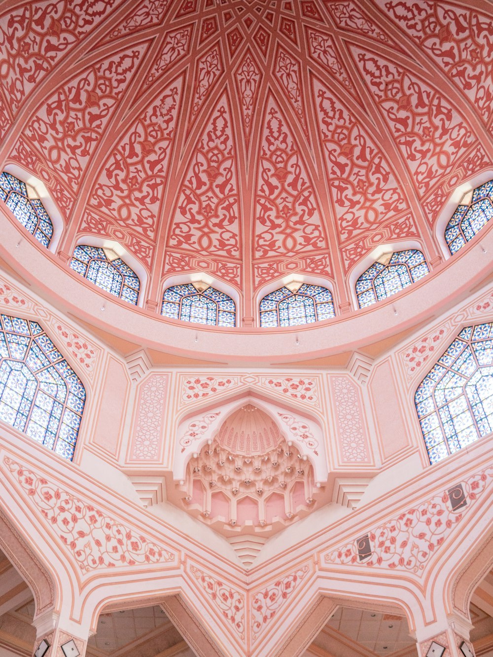 the ceiling of a large building with many windows