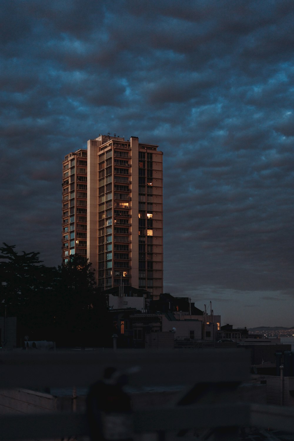 a very tall building sitting under a cloudy sky