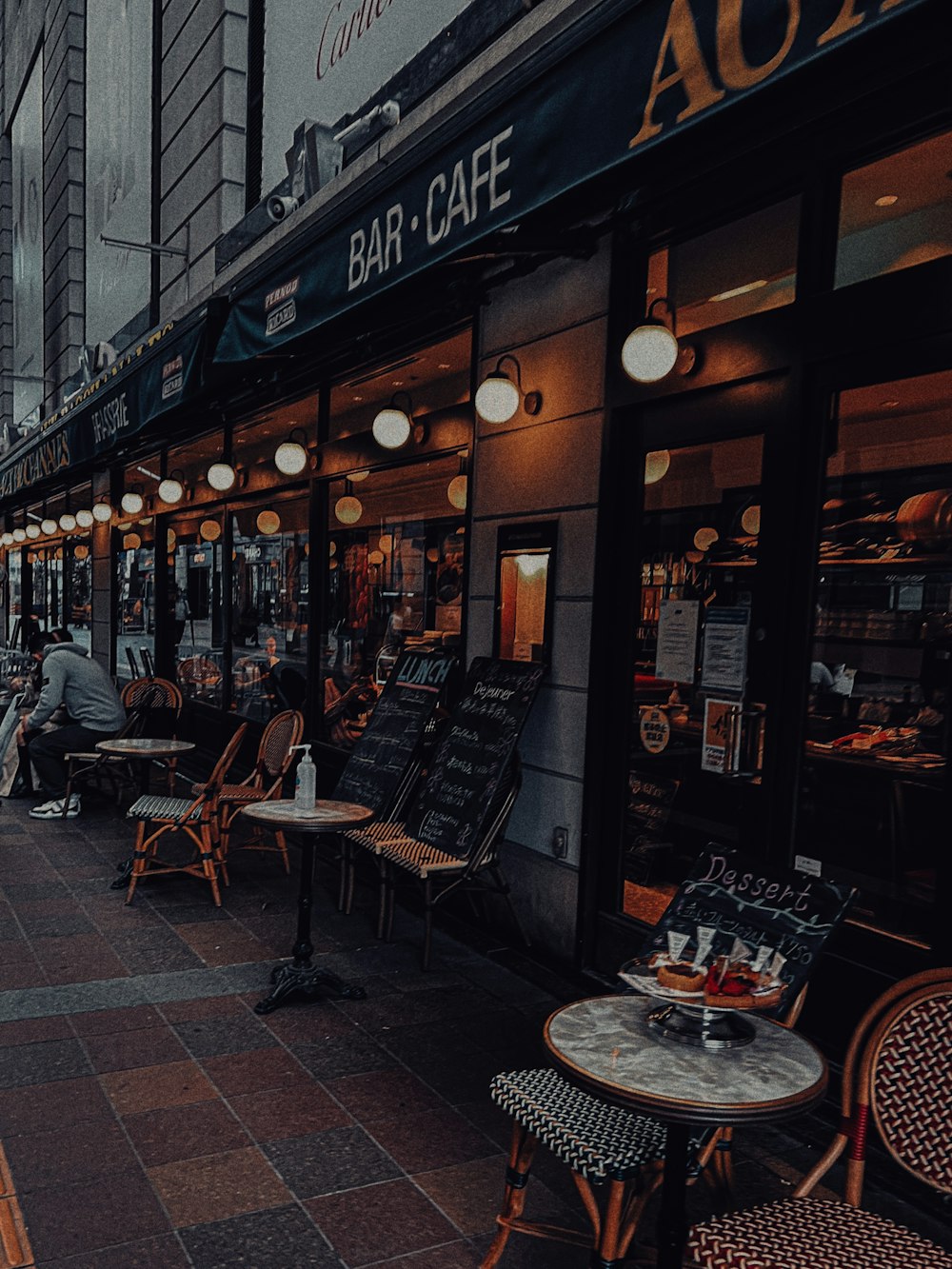 a row of tables and chairs outside of a restaurant