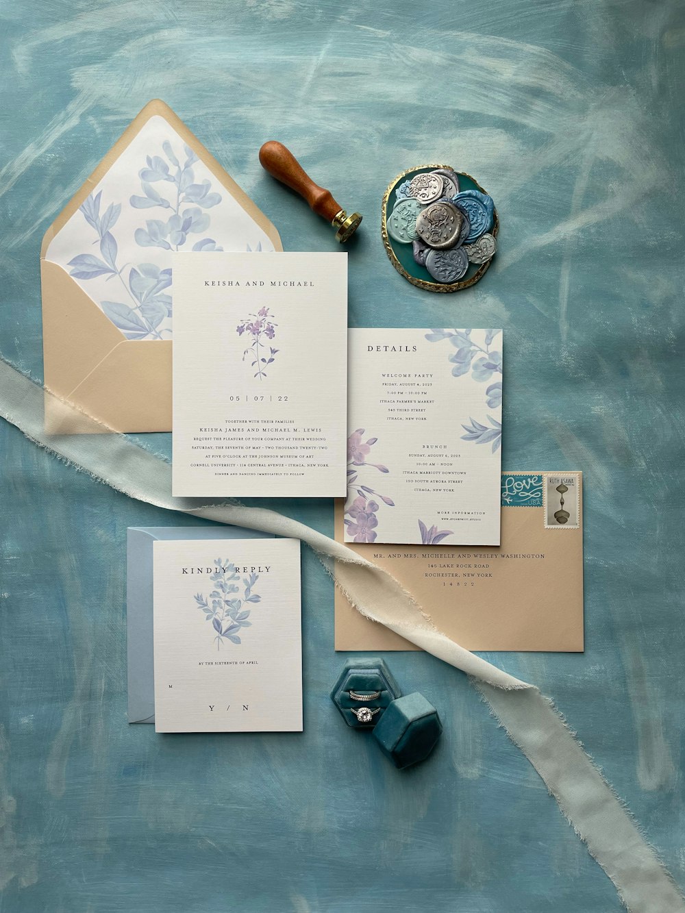 a blue and white wedding suite with a wax stamp