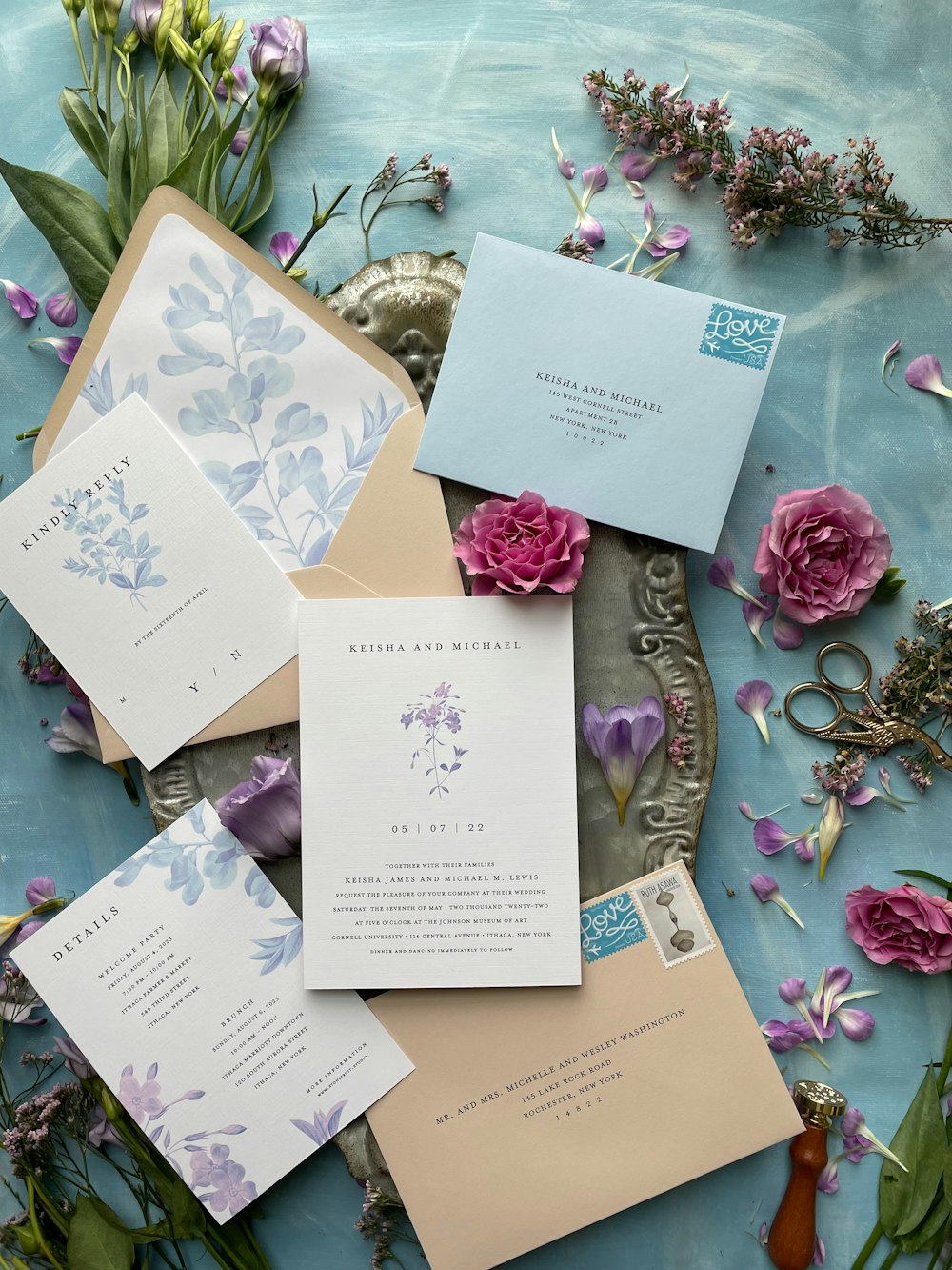 a table topped with lots of cards and flowers