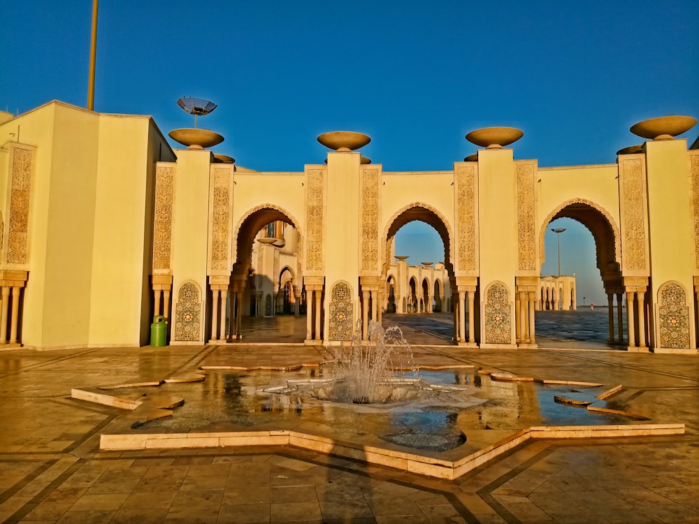 a large building with a fountain in front of it