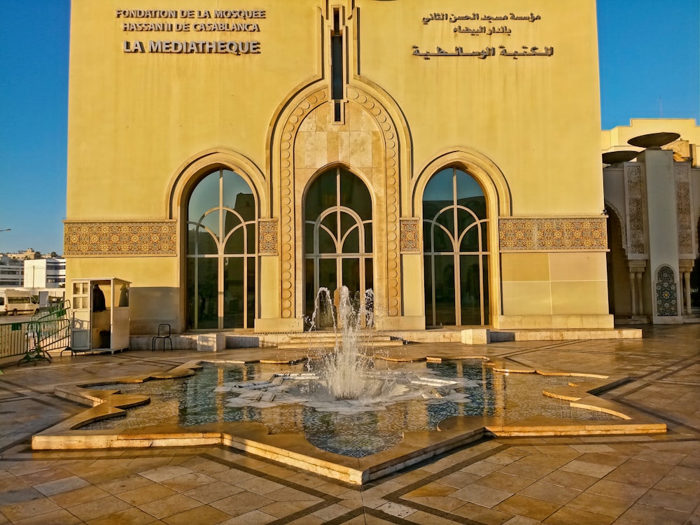 a large building with a fountain in front of it