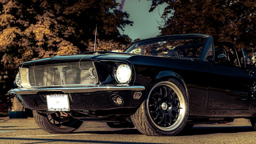 a black mustang sitting in a parking lot