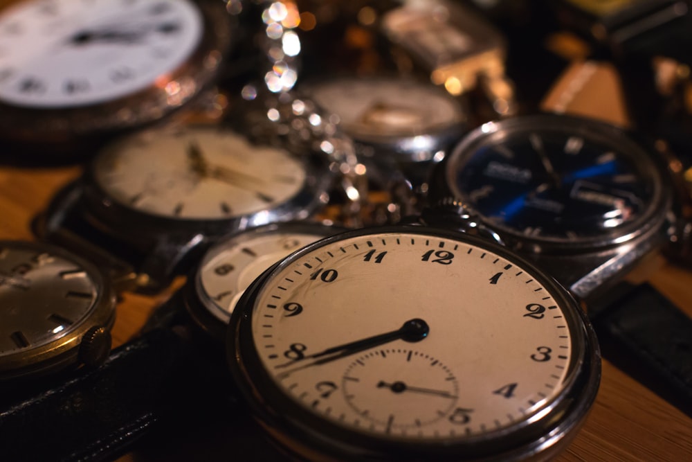 a close up of a bunch of clocks on a table