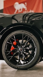 a close up of a black sports car tire