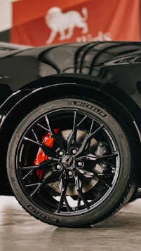 a close up of a black sports car tire